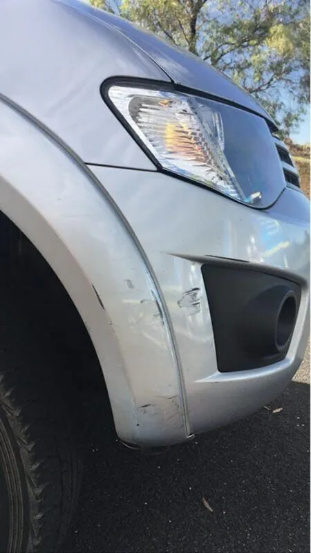 Before: scraped bumper and fender restored