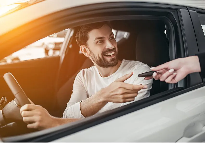 Smiling customer receiving his car keys