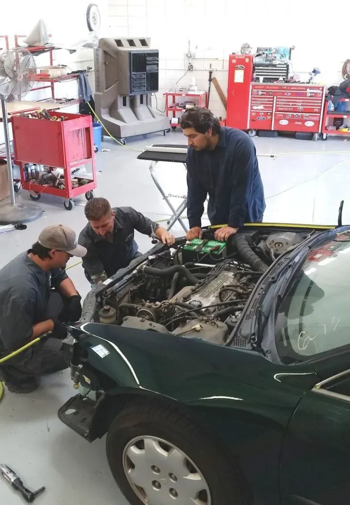 Technicians working on an engine bay