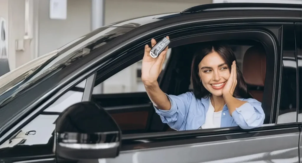 Happy driver holding up her car keys