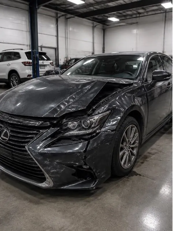 Before: front-end collision repair on a dark sedan