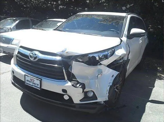 Before: front-corner collision repair on a white SUV